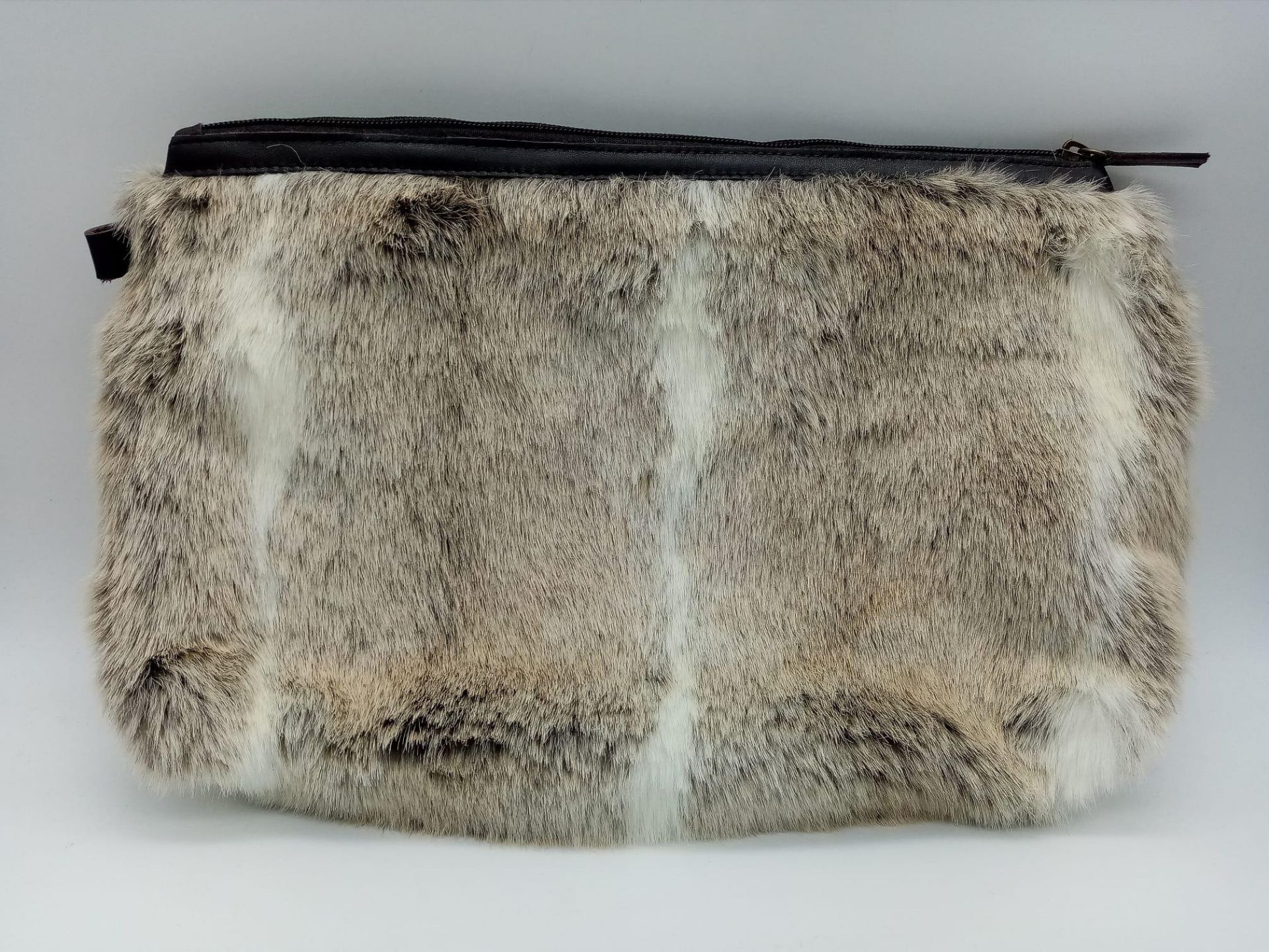 A super soft, Ceannis Faux Fur Zip Clutch Bag. Made in Sweden, this bag measures 39cm wide and feels