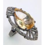 An exquisite 24ct Citrine stone, framed by 1.10ctw of Diamonds and set on a 925 Sterling Silver.