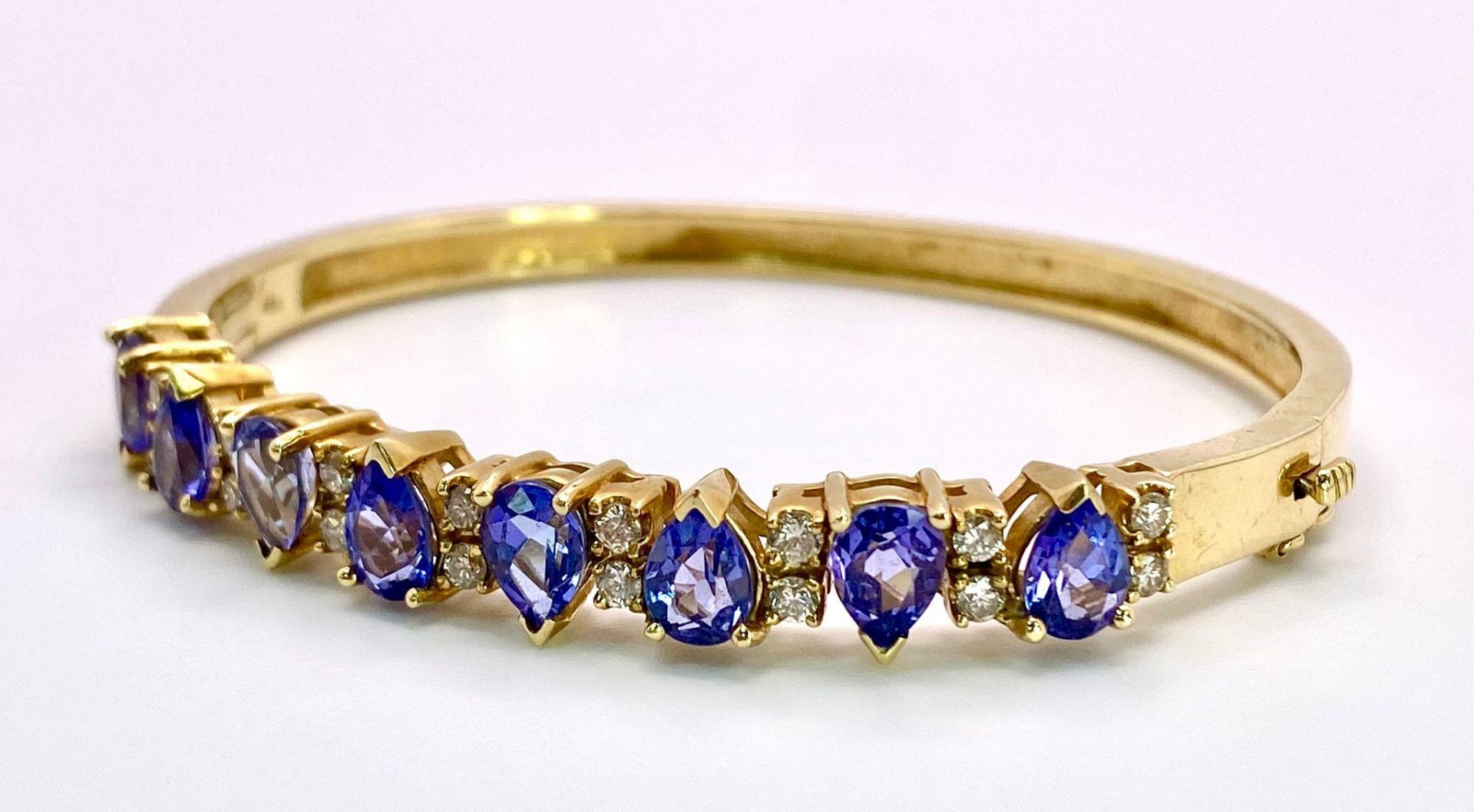 An Alluring 14K Yellow Gold, Amethyst and Diamond Bangle. High-grade, clean pear-cut amethysts - Image 3 of 10