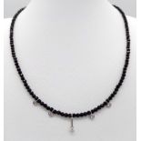 A Black Spinel Small Bead Necklace with Five Stone White Diamond Decoration. 0.5ctw. 14k gold clasp.