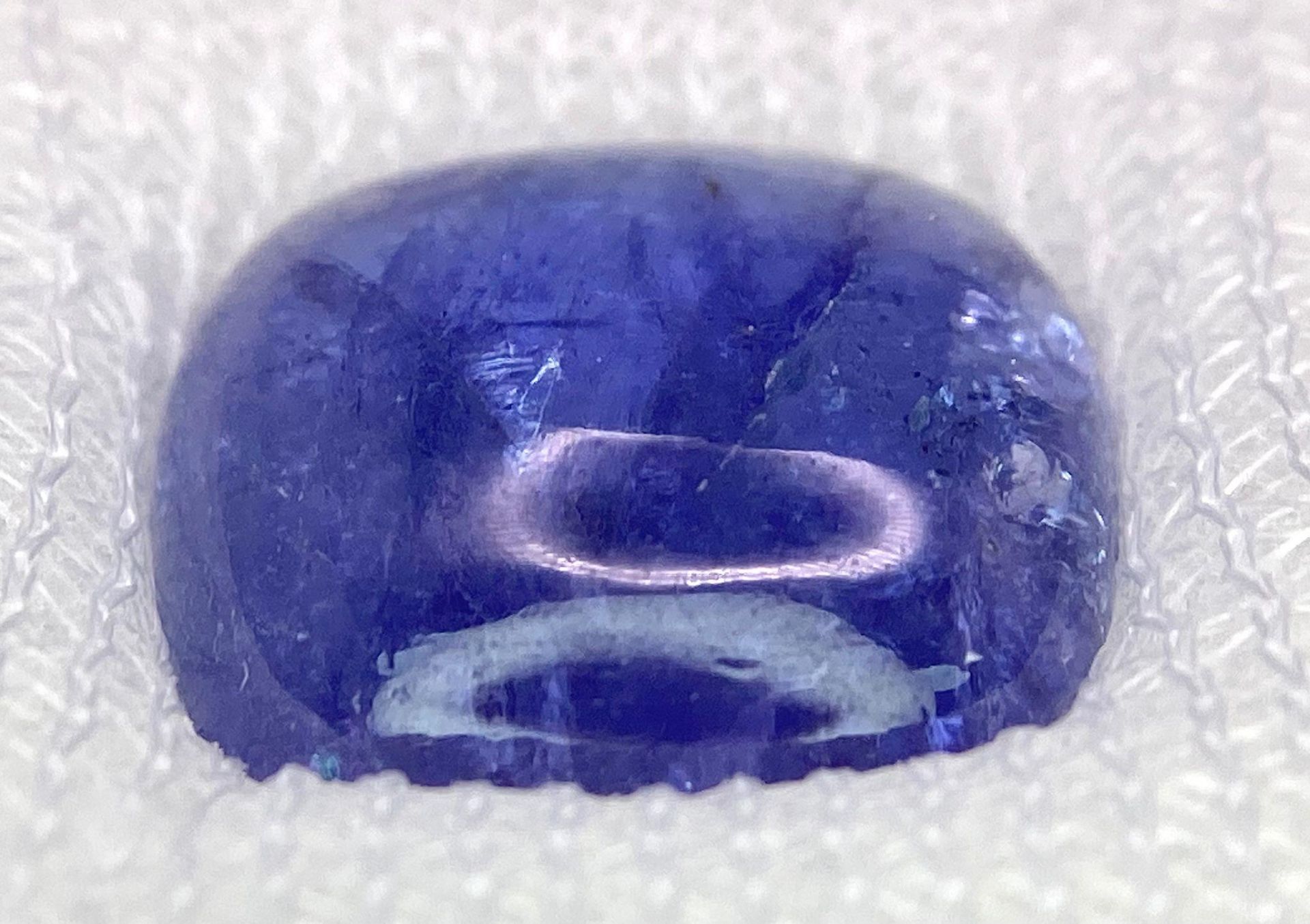 A 10.87ct Tanzania Natural Tanzanite Gemstone, in the Cushion Cabochon shape. Comes with the AIG - Image 2 of 5