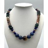 A Tigers Eye, Jade and Lapis Lazuli Necklace. A mixture of rondelle and round beads. Largest central