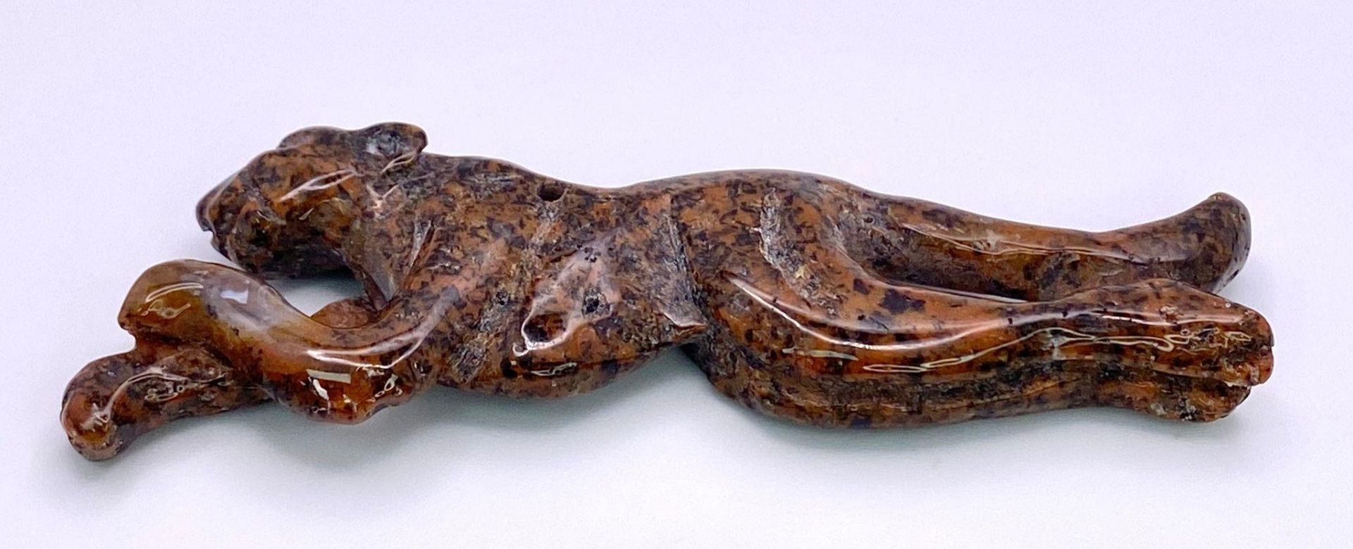 A carved Leopard, natural stone pendant. Measuring 7.5cm wide, the spotted colours of this carved