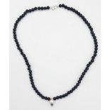 A Lava Volcanic Bead Necklace with Pearl and 0.10 Blue Diamond Pendant. 40cm.