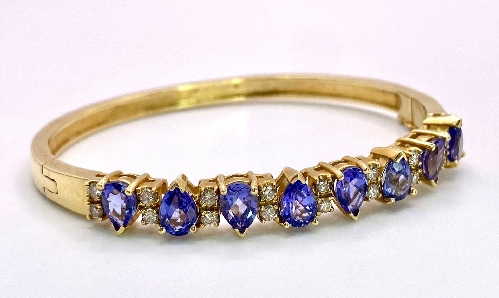 An Alluring 14K Yellow Gold, Amethyst and Diamond Bangle. High-grade, clean pear-cut amethysts - Image 5 of 10