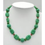 An Antique Chinese Green Turquoise Hand-Carved Necklace. With coral spacers. 35cm. 30.33g