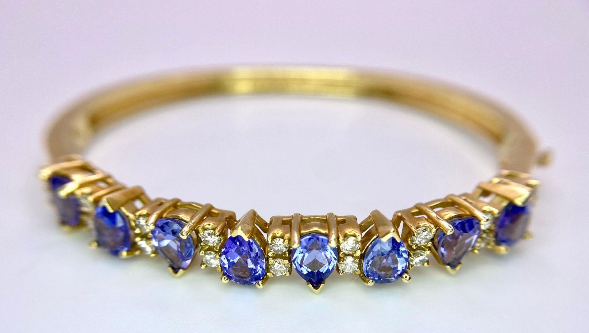 An Alluring 14K Yellow Gold, Amethyst and Diamond Bangle. High-grade, clean pear-cut amethysts - Image 2 of 10