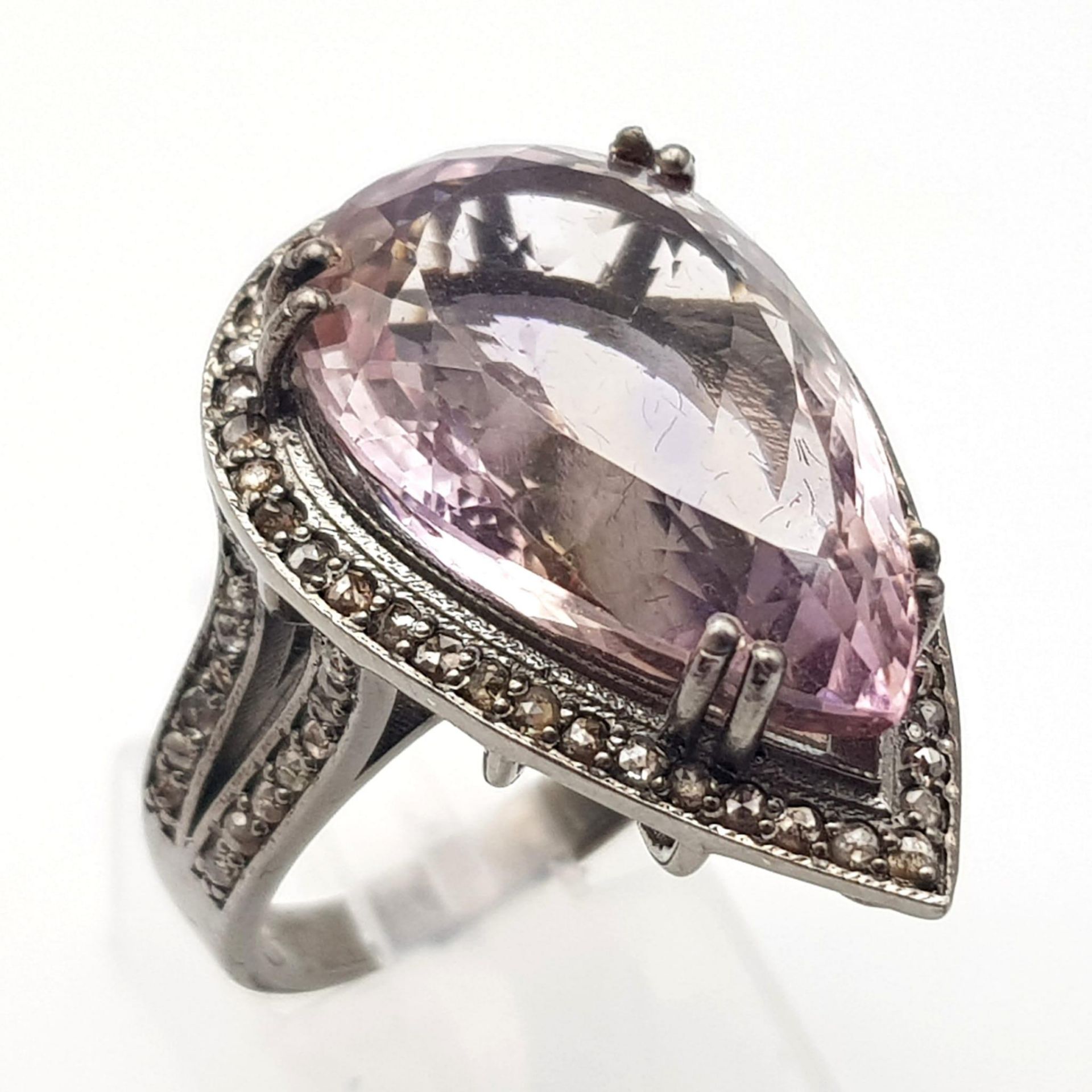 A 15ct Amethyst Gemstone Ring with 0.90ctw of Diamonds set in 925 Silver. A beautiful pear shaped