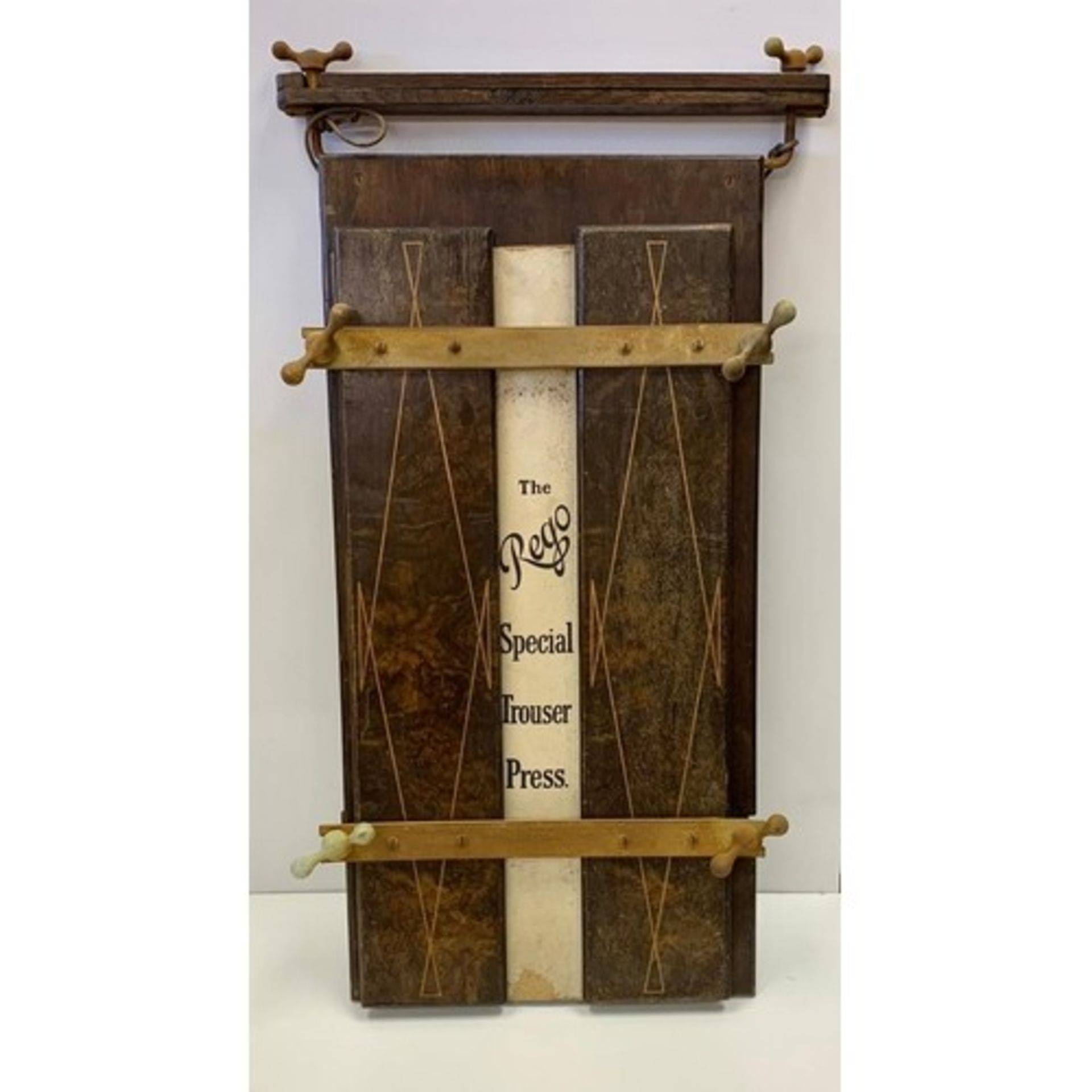 Victorian style antique trouser press wood and metal frame with white leather. Inscription on back