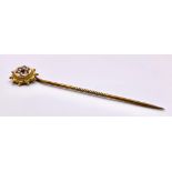 An Antique Mid-Karat Gold, Seed Pearl and Ruby Stick-Pin. 5.5cm. 0.91g total weight.