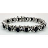 An Oval Cut Blue Sapphire Tennis Bracelet set in 925 Sterling Silver. 33ctw. W-25g. 18cm length.