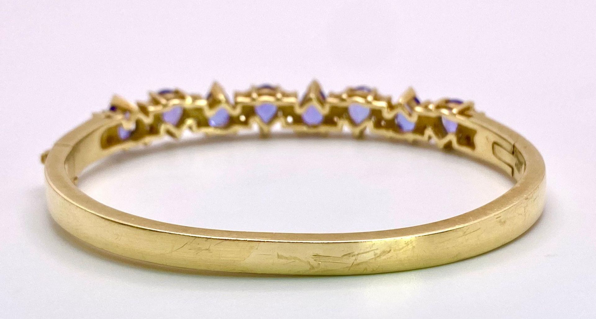 An Alluring 14K Yellow Gold, Amethyst and Diamond Bangle. High-grade, clean pear-cut amethysts - Image 9 of 10