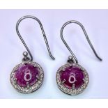 A Pair of Ruby and Diamond 925 Silver Earrings. Ruby cabochons with diamond halos. Ruby - 4ctw