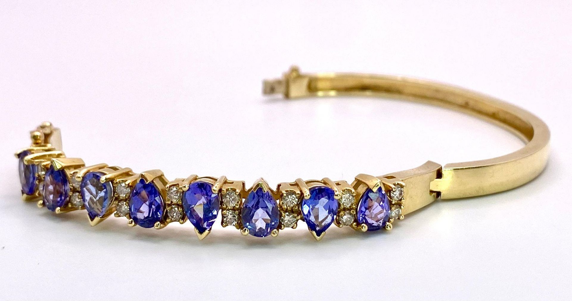 An Alluring 14K Yellow Gold, Amethyst and Diamond Bangle. High-grade, clean pear-cut amethysts - Image 6 of 10