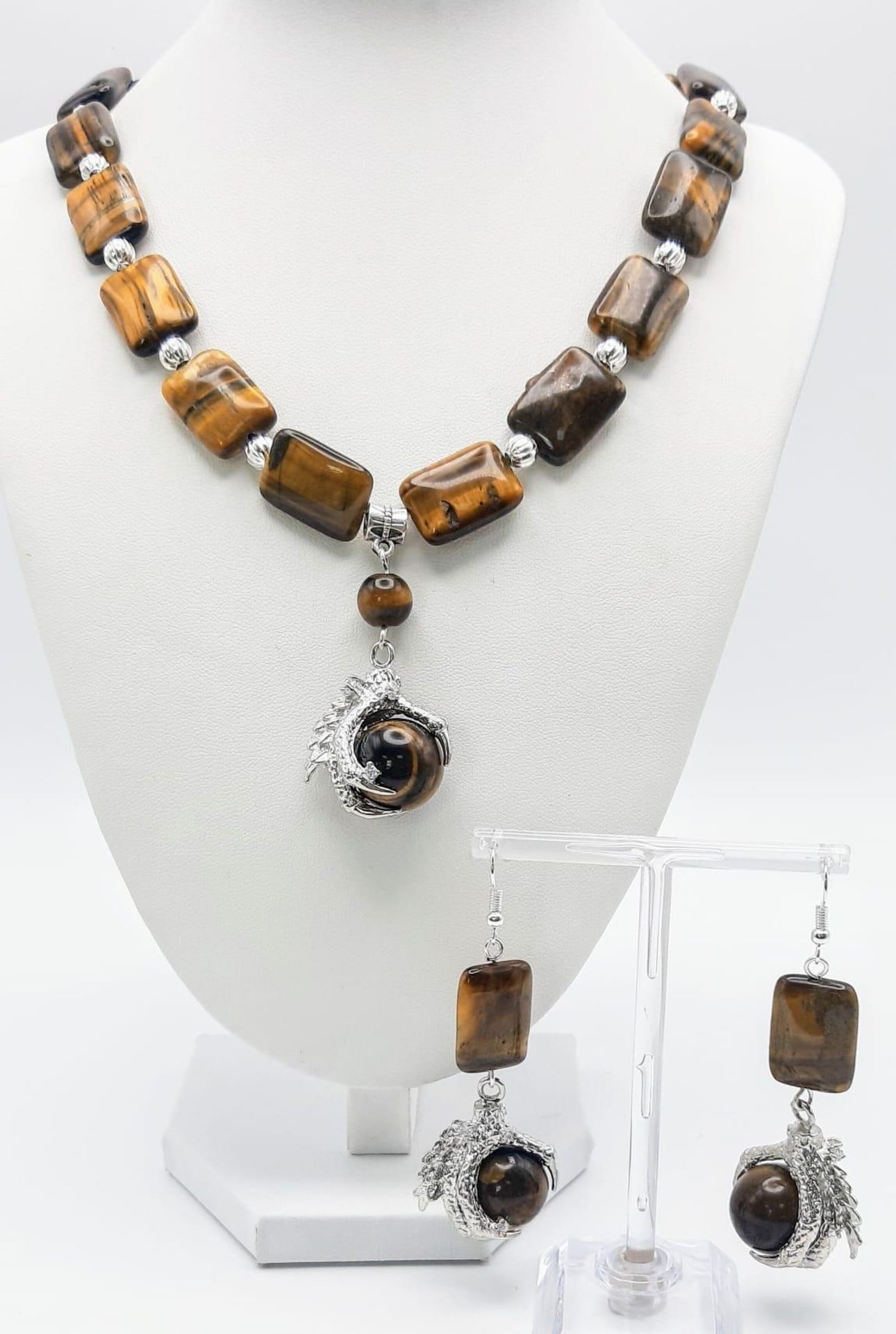 A substantial tiger’s eye necklace and earrings set with eagle claw pendants, beads 20 x 15 x 7