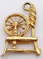 A Vintage 9K Yellow Gold Spinning Wheel Pendant/Charm. 2cm. 1.5g weight.