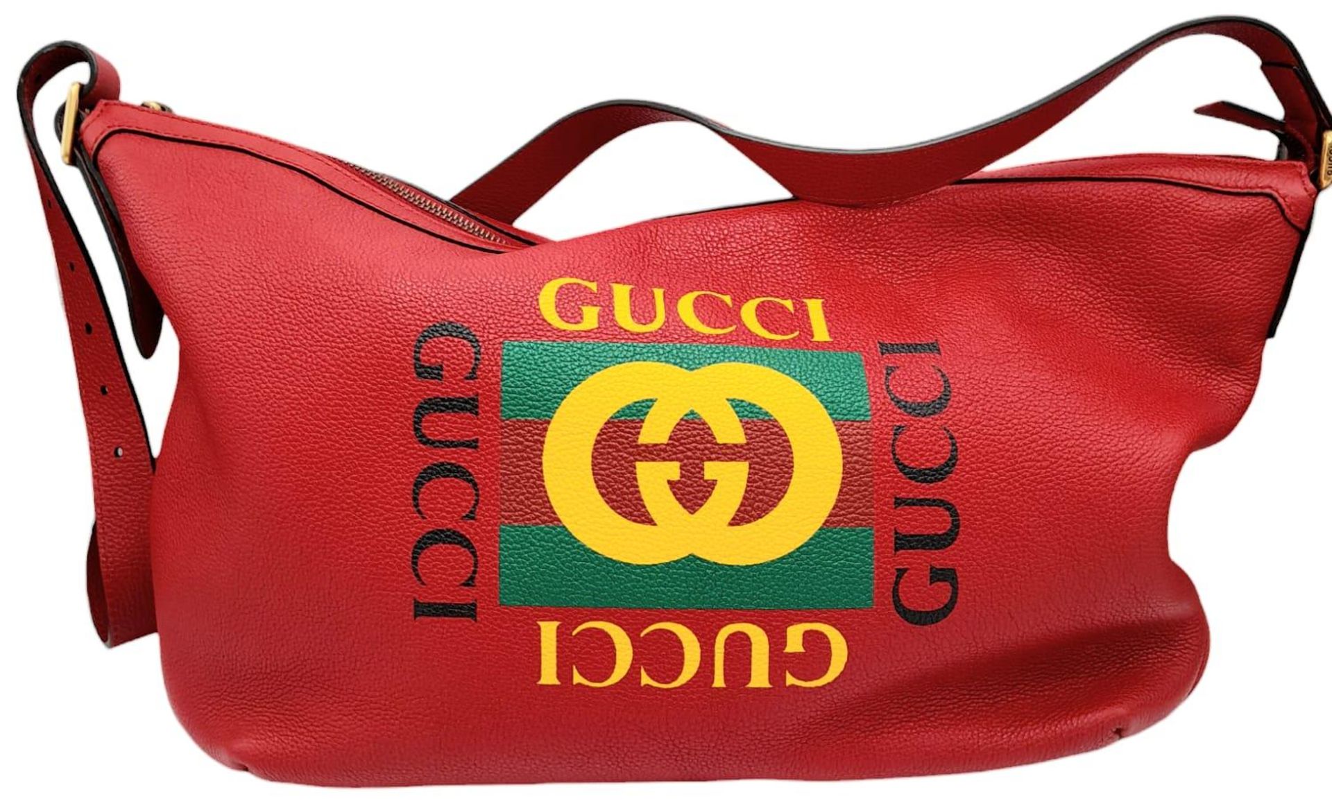 A Gucci Red Logo Shoulder Bag. Leather exterior with gold-toned hardware, adjustable strap and