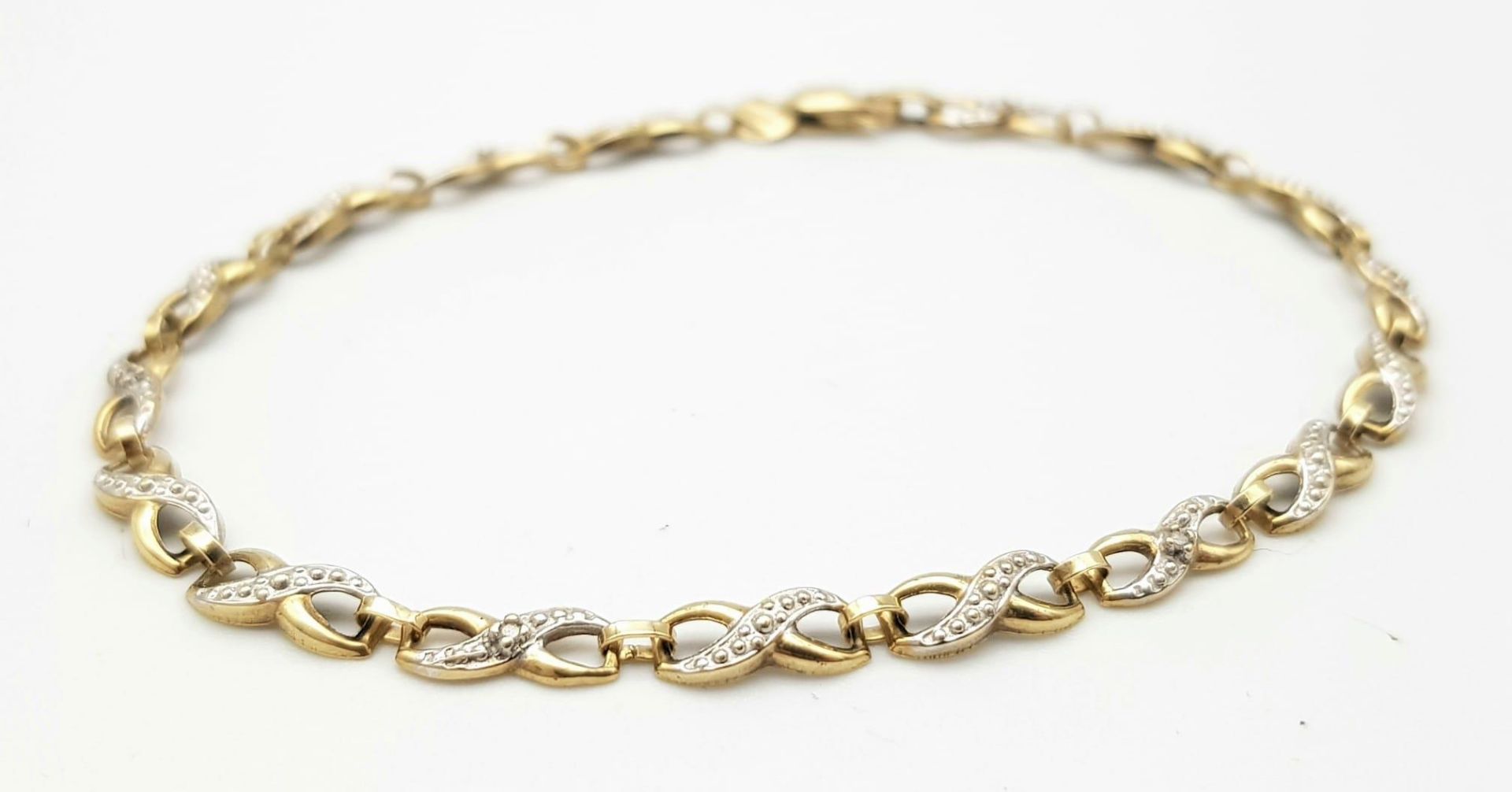 A Vintage 9K Yellow Gold and Diamond Spacer Crossover Link Bracelet. 18cm length. 2.37g total - Image 2 of 4