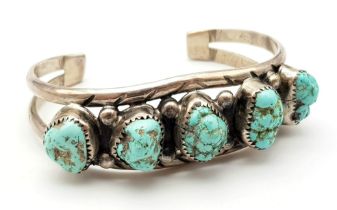 A Vintage Native American Indian Silver and Kingman Turquoise Cuff Bracelet. 34.2g total weight.