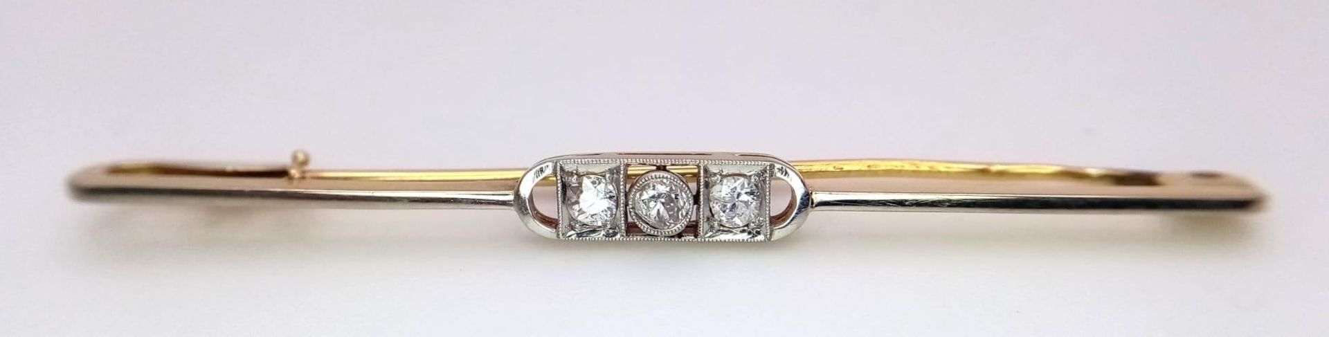 An 18k yellow gold diamond set tie pin with safety catch. 3.6g (dia:.30ct)