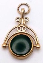 AN ANTIQUE 9K GOLD WATCH FOB WITH 2 COLOURED SPINNER .. 2.8gms