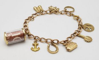 A 9K Gold Charm Bracelet. 10 charms including: 10 shilling note, handbag and binoculars! 18cm