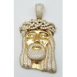 An 18K Yellow Gold Jesus Encrusted Diamond Pendant. Beautifully crafted with 7ctw of bright white