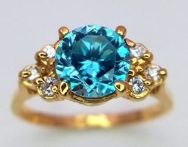 A BLUE ZIRCON GEMSTONE FLANKED BY 6 SMALL DIAMONDS SET IN 18K GOLD .. A VERY PRETTY RING! 2.8gms