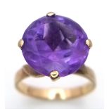 A Vintage 9K Yellow Gold Amethyst Ring. Large round cut amethyst in a raised setting. Size J. 3.