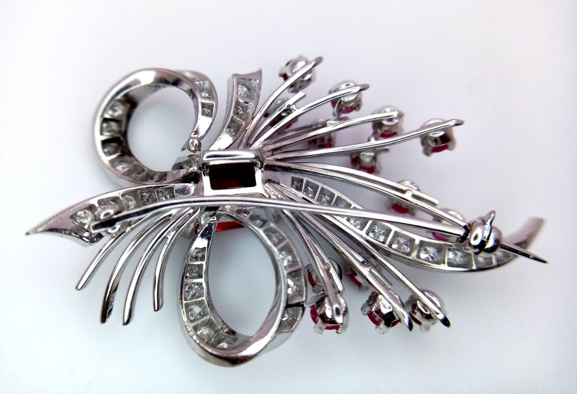 A STUNNING DIAMOND AND RUBY BROOCH SET IN PLATINUM , A MAJESTIC SPRAY OF RUBIES EMINATING FROM A - Image 7 of 7