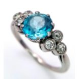 A 9K WHITE GOLD PALLADIUM DIAMOND AND BLUE TOPAZ RING . 3.2gms size N