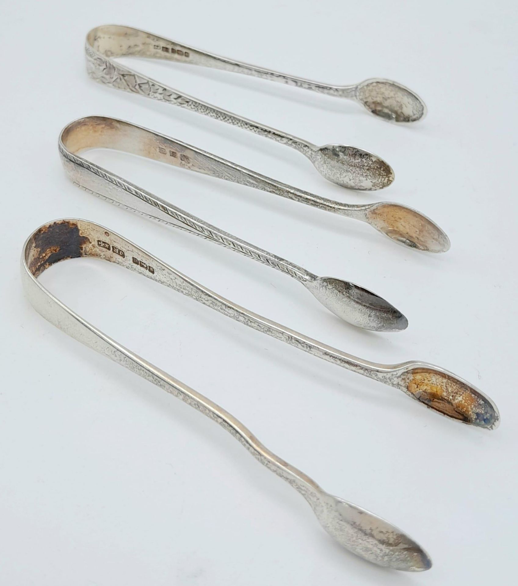 3X antique sterling silver sugar tongs with different designs. 2 of them come with Full London