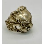 A vintage Chinese silver ring with a Mythological Chinese Lion. Chinese marks on the inside of the
