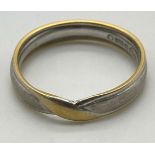 An 18K White and Yellow Gold Crossover Band Ring. Size L. 3.4g weight.