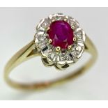 A 9K GOLD DIAMOND AND RUBY CLUSTER RING . 1.8gms size M