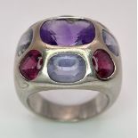 A Chanel Designer 18K White Gold and Amethyst and Garnet Ring. Rectangular cut central amethyst with
