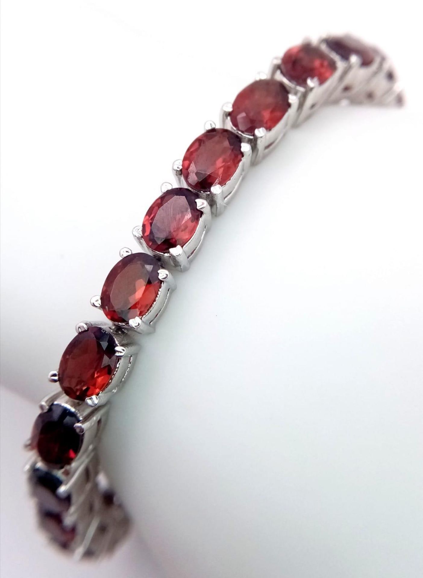 A Hessonite Garnet Gemstone Tennis Bracelet set in 925 Silver. 24.2g total weight. 18cm. Ref: HV -