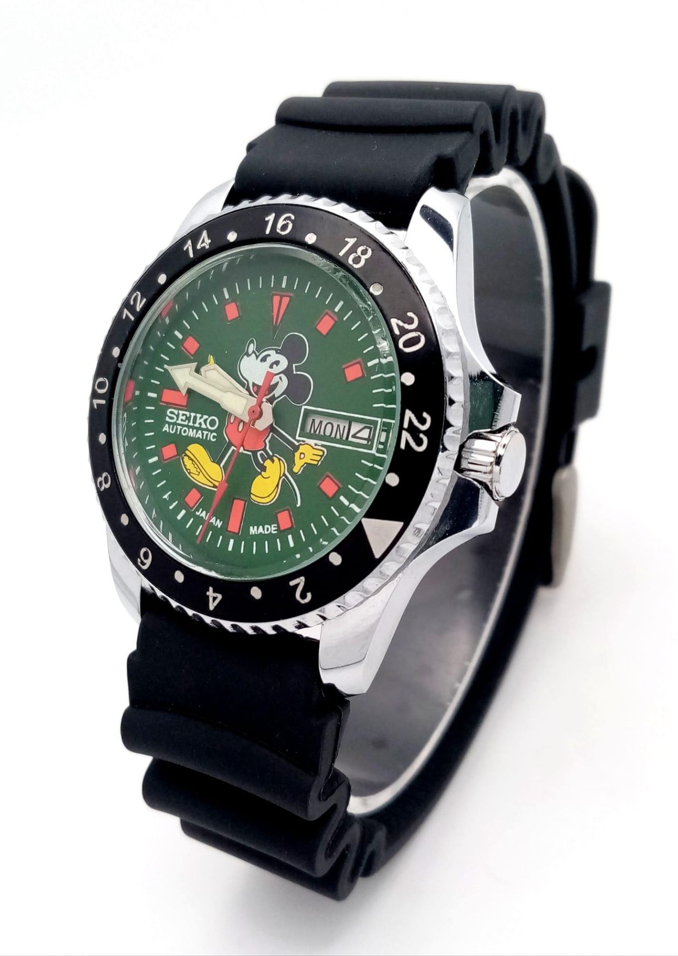 A Seiko Automatic Mickey Mouse Watch. Black rubber sport strap. Stainless steel case with black