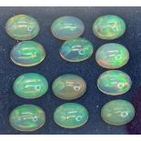 An eclectic collection of a dozen, top quality, Australian OPAL, oval cabochons with excellent