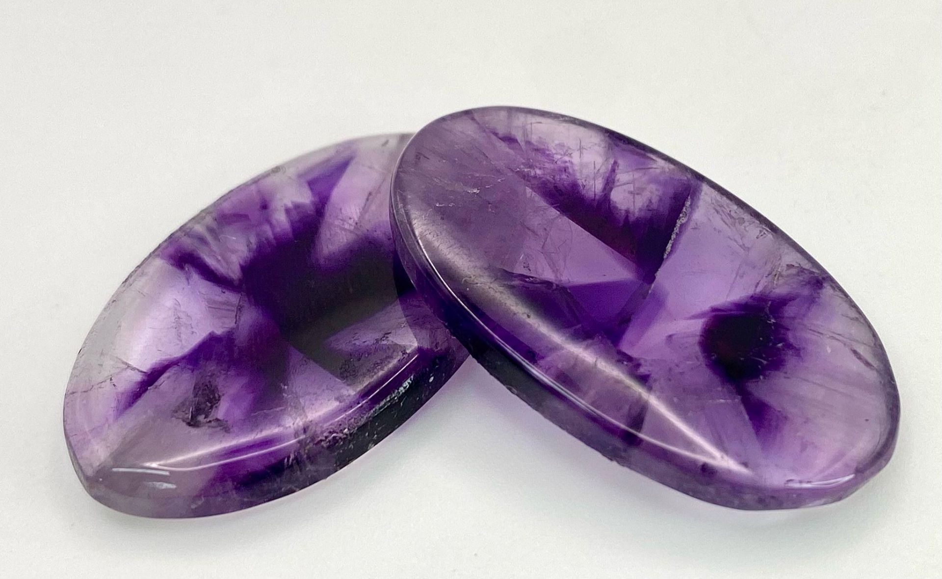 A rarely seen and very desirable pair of large AMETHYST cabochons, exhibiting radiating banded