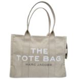 A Marc Jacobs Beige 'The Tote Bag'. Canvas exterior with two handles, and top zip closure. Canvas