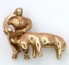 A 9K YELLOW GOLD BULL AND BULL FIGHTER CHARM. TOTAL WEIGHT 2G