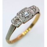 An Antique 18K Yellow Gold and Diamond Trilogy Ring. Three diamonds in a platinum setting. Size O.