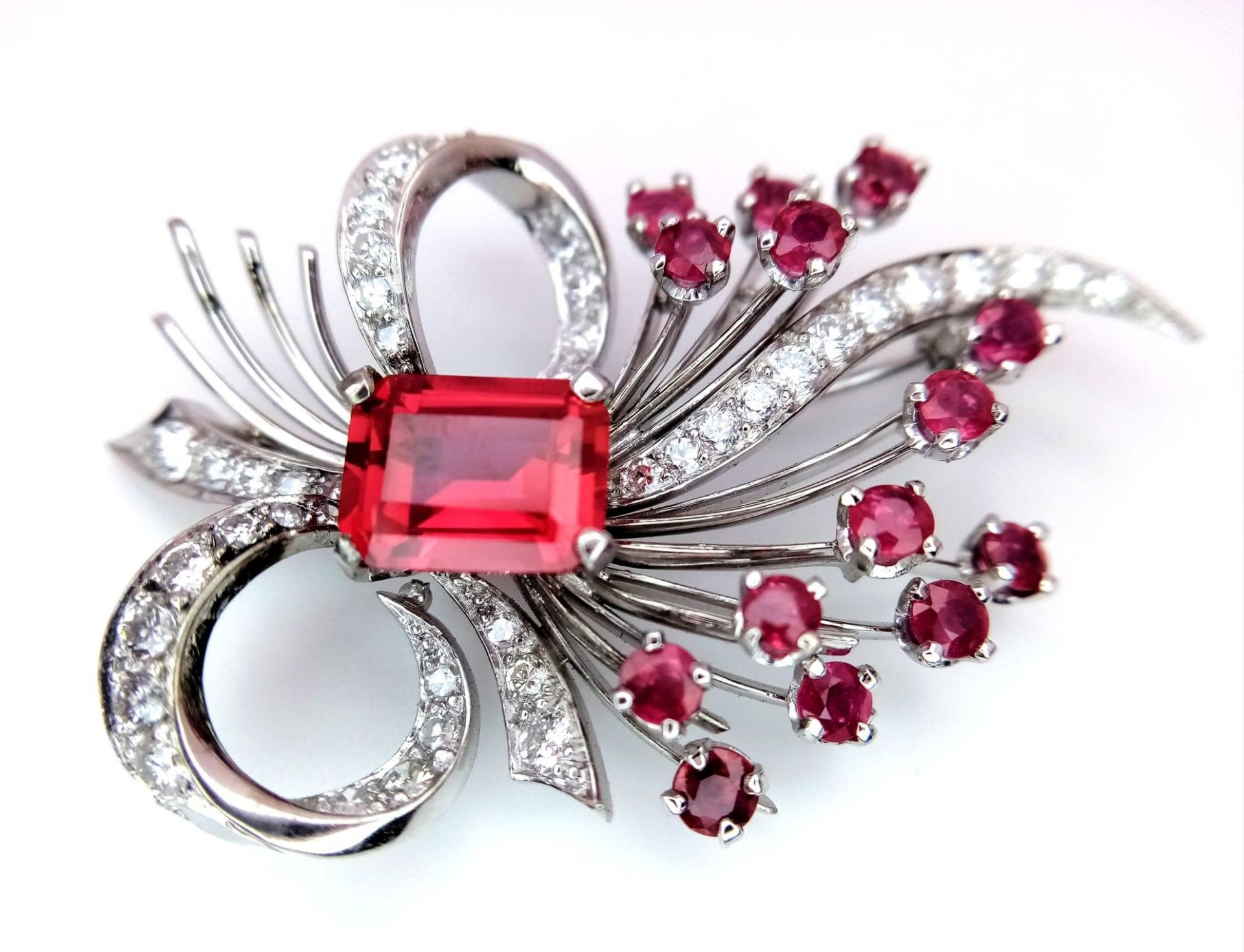 A STUNNING DIAMOND AND RUBY BROOCH SET IN PLATINUM , A MAJESTIC SPRAY OF RUBIES EMINATING FROM A - Image 2 of 7