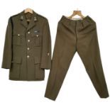 A British Army Officer’s Service Dress jacket and trousers, mid-1960s vintage, with insignia for a