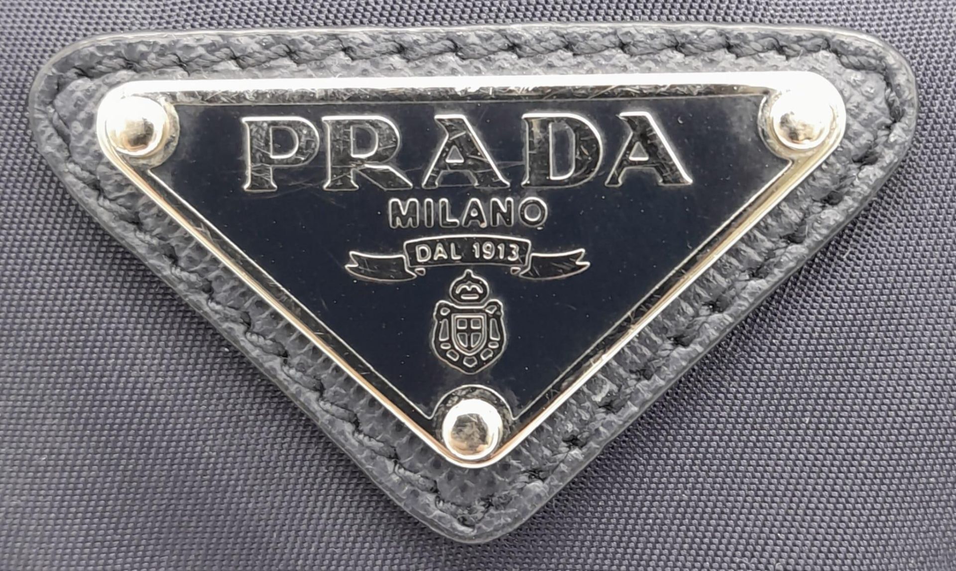 A Prada Navy Blue Mini Backpack. Textile exterior with silver-toned hardware, leather top handle, - Image 8 of 9