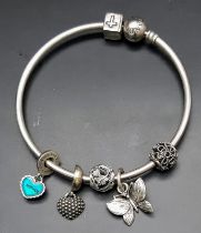 A vintage 925 silver Pandora charm bangle. Total weight 26.3G. Diameter 7.5cm. Please see photos for