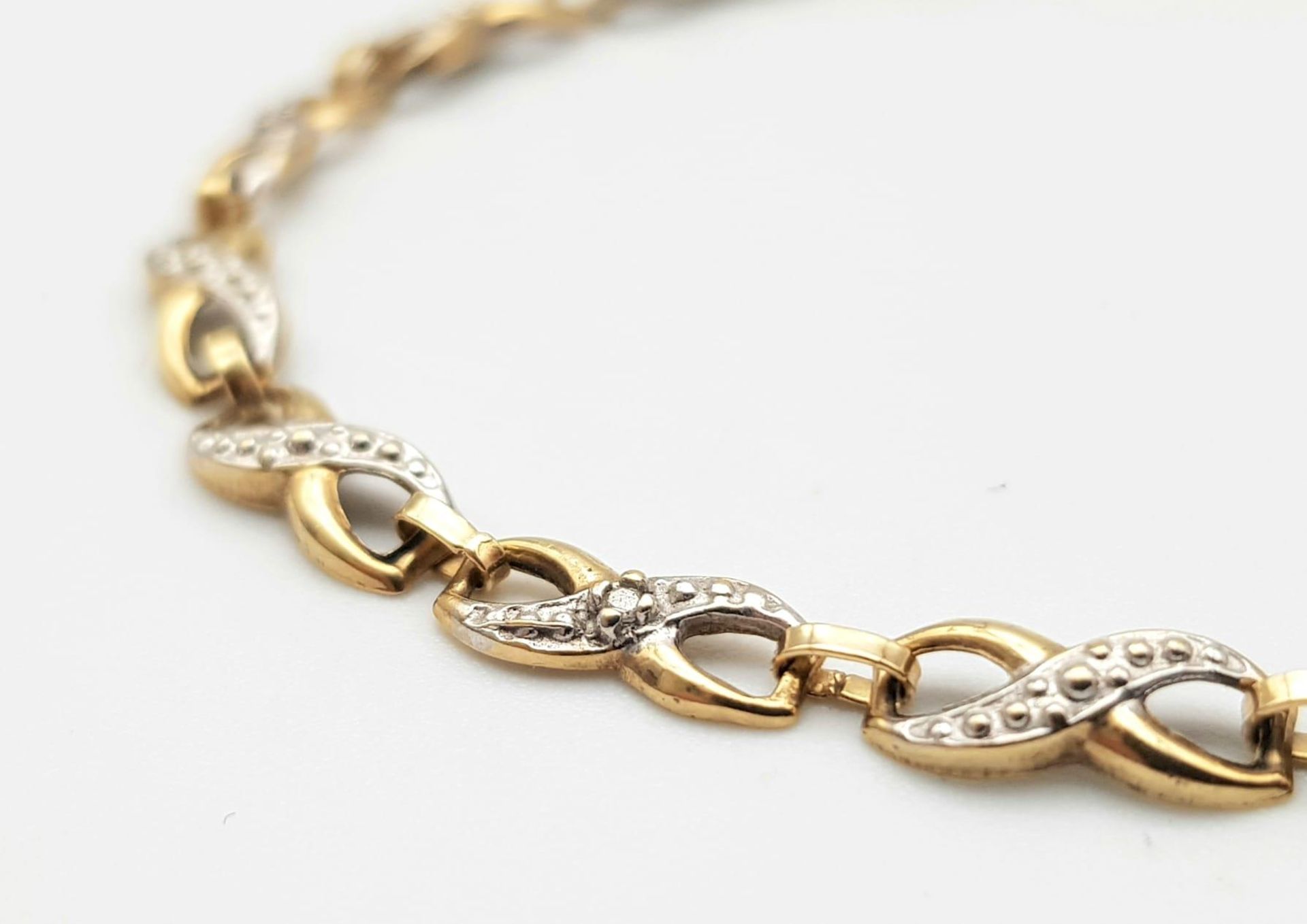 A Vintage 9K Yellow Gold and Diamond Spacer Crossover Link Bracelet. 18cm length. 2.37g total - Image 3 of 4