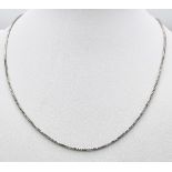A 14K White Gold Disappearing Necklace. 40cm length. 3.35g weight.