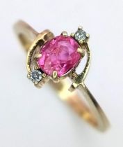 A 14K Yellow Gold Ruby and Diamond Ring. Central ruby with diamond accents. Size N. 2.1g total